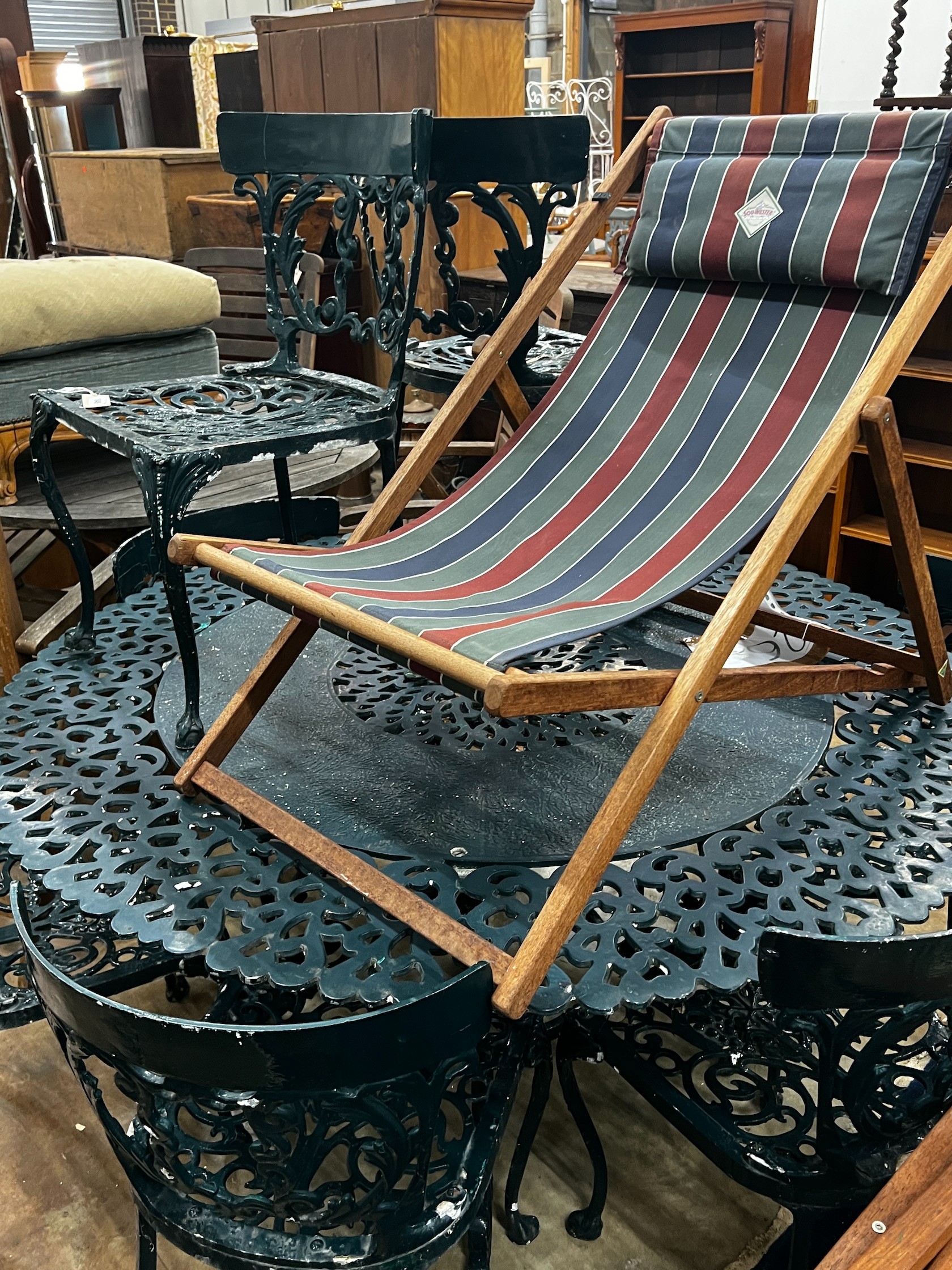 A Victorian style circular aluminium garden table and eight aluminium garden chairs, table 142cm diameter height 71cm